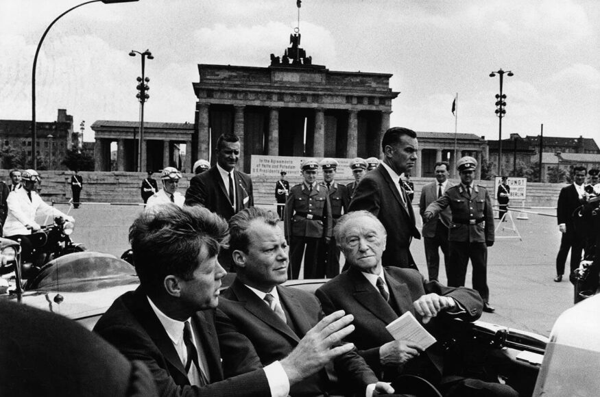 WILL MCBRIDE. President John F. Kennedy, Berlin Mayor Willy Brandt, and German Chancellor Konrad Adenauer at the Brandenburg Gate Berlin, June 26, 1963. © Will McBride / Courtesy of CAMERA WORK Gallery.